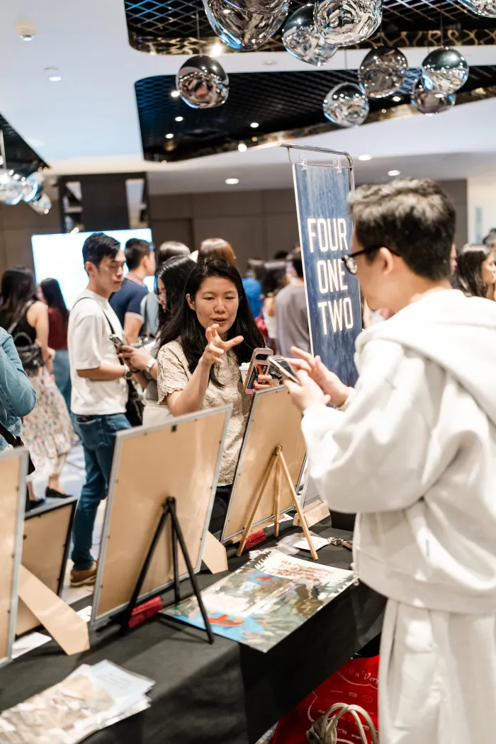 Four One Two scripture art prints at a pop-up market in Singapore — photo 4
